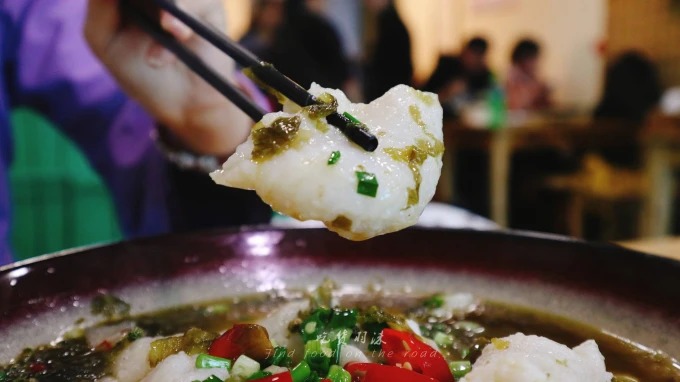 Sour pickled vegetable fish in a shallow bowl