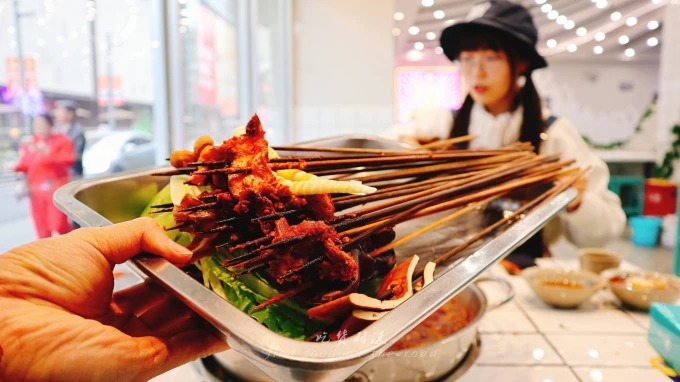 Beef skewers and other items cooked in spicy broth