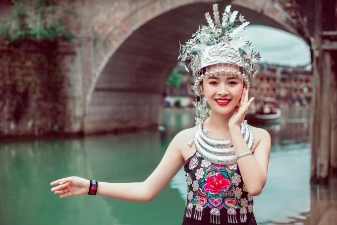 Visitor wearing Miao-style dress in Fenghuang old town