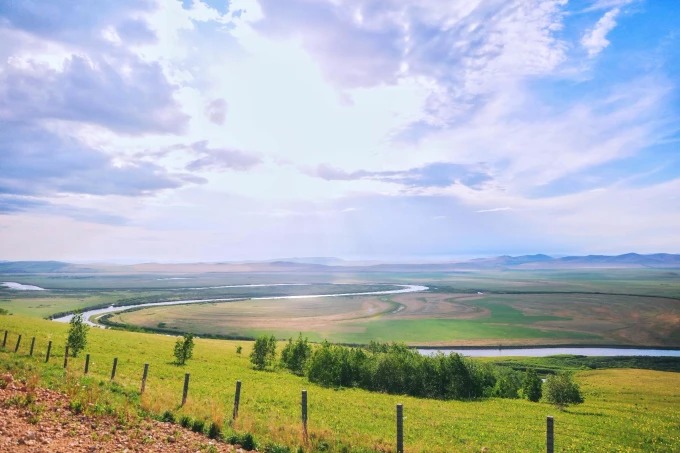 Border road landscape with fields and hills