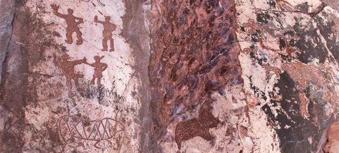 Petroglyph carvings on dark rock at Heishan