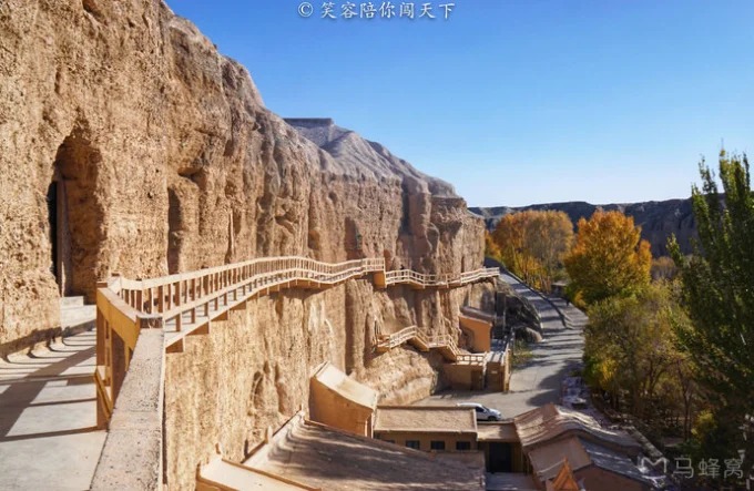 Cave openings cut into the cliff at Yulin Grottoes