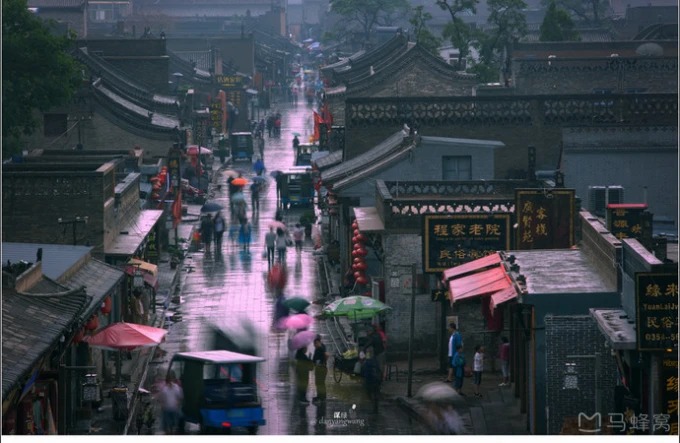 Wet stone streets and old rooftops in Pingyao's walled town
