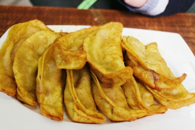 Plate of pan-fried guotie dumplings at a Jiang Youji snack shop