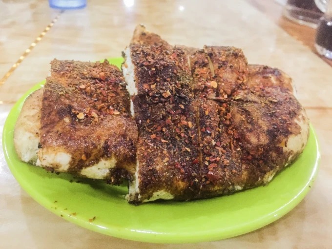 Un pan plano redondo a la parrilla con una corteza sabrosa