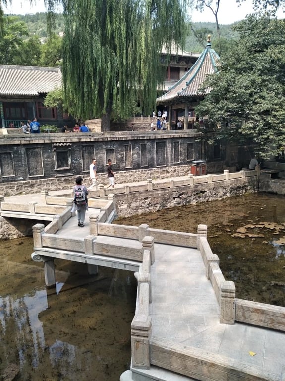 Curved bridge leading toward the Nanlao Spring pavilion