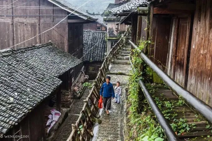 Stone steps between timber houses in Xijiang