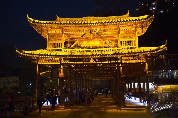Covered bridge illuminated at night in Xijiang