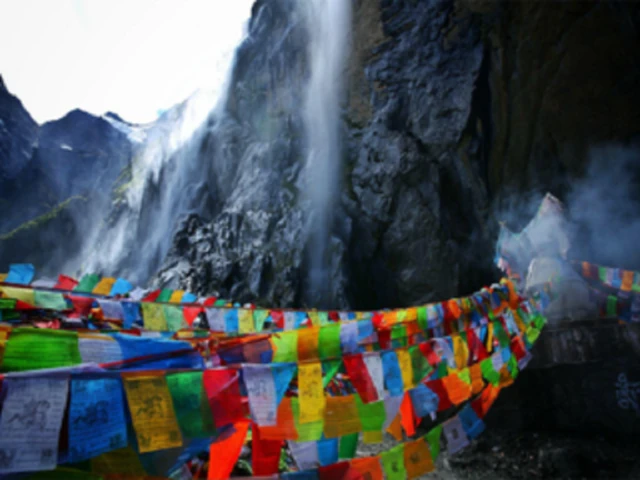 Waterfall, rock face and prayer flags