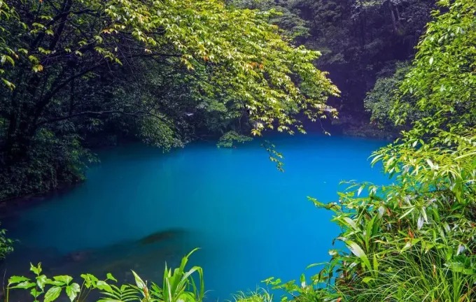 Blue pool among the trees at Tiexi near Zhenyuan